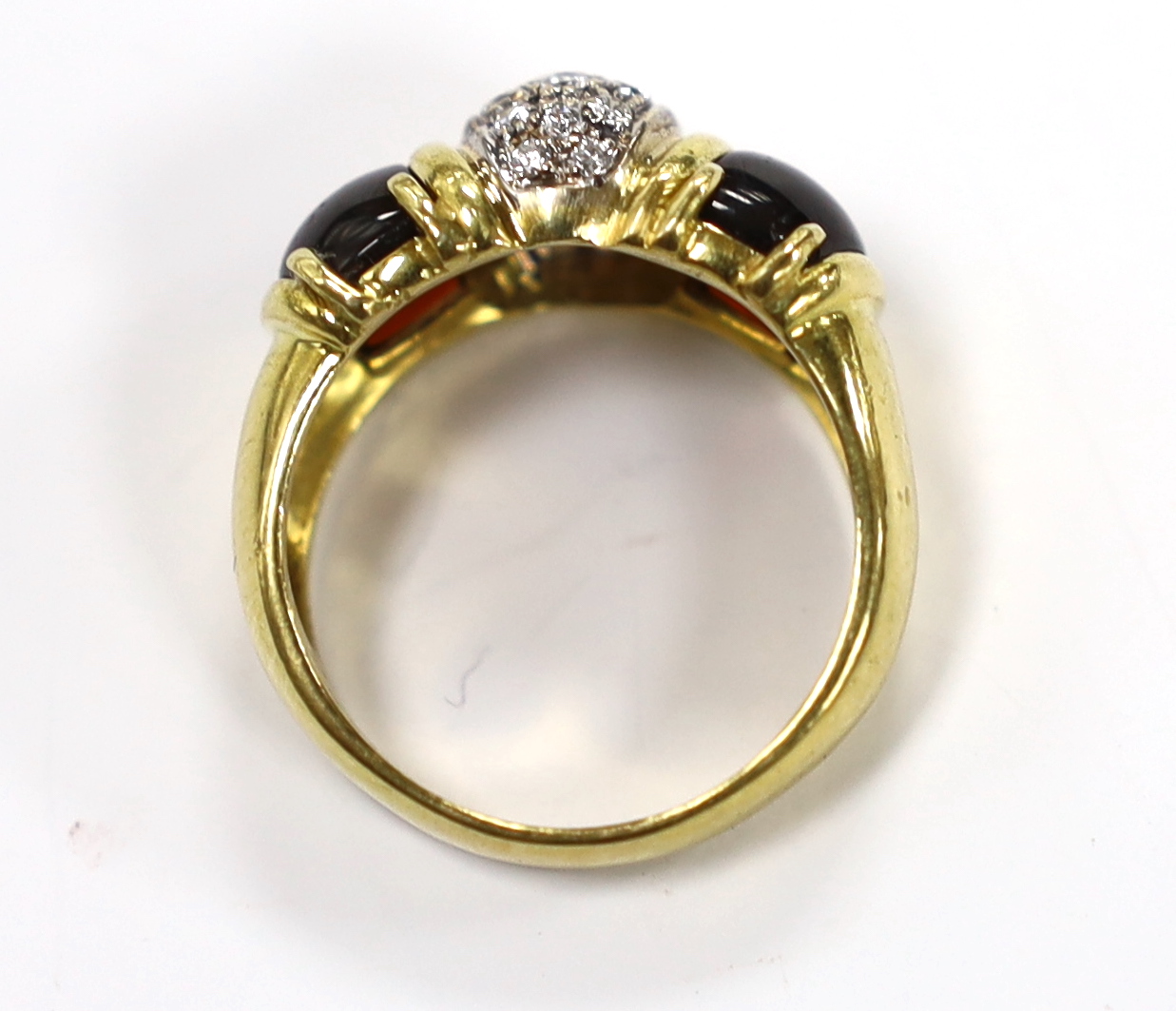 A modern 750 yellow metal and diamond cluster set dress ring, with two stone cabochon garnet set shoulders, size Q, gross weight 9.7 grams.